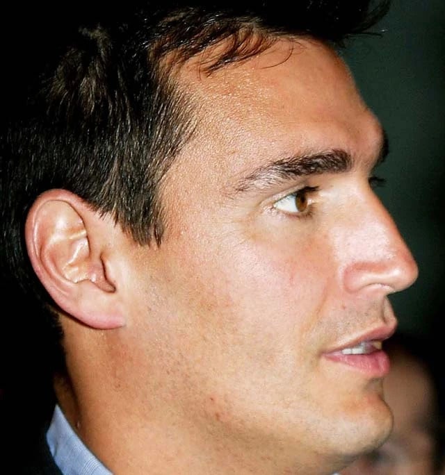 AJ DiScala in a light blue shirt and black coat.